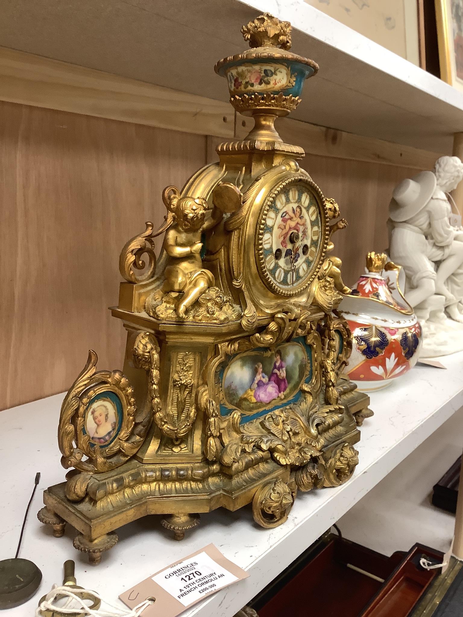 A 19th century French ormolu and Sevres style porcelain mounted mantel clock, with key and pendulum, 35 cm high